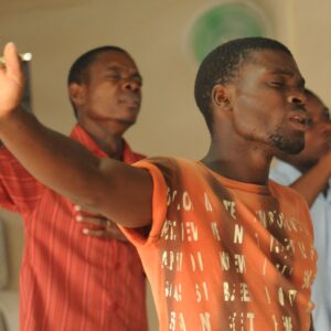 Two men worshiping in church