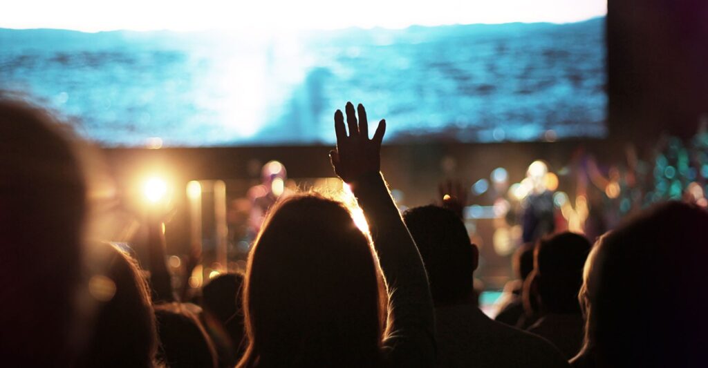 a person holding their hand up in prayer