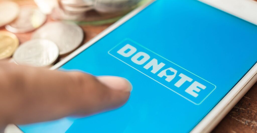 Someone using a donation app on a smartphone